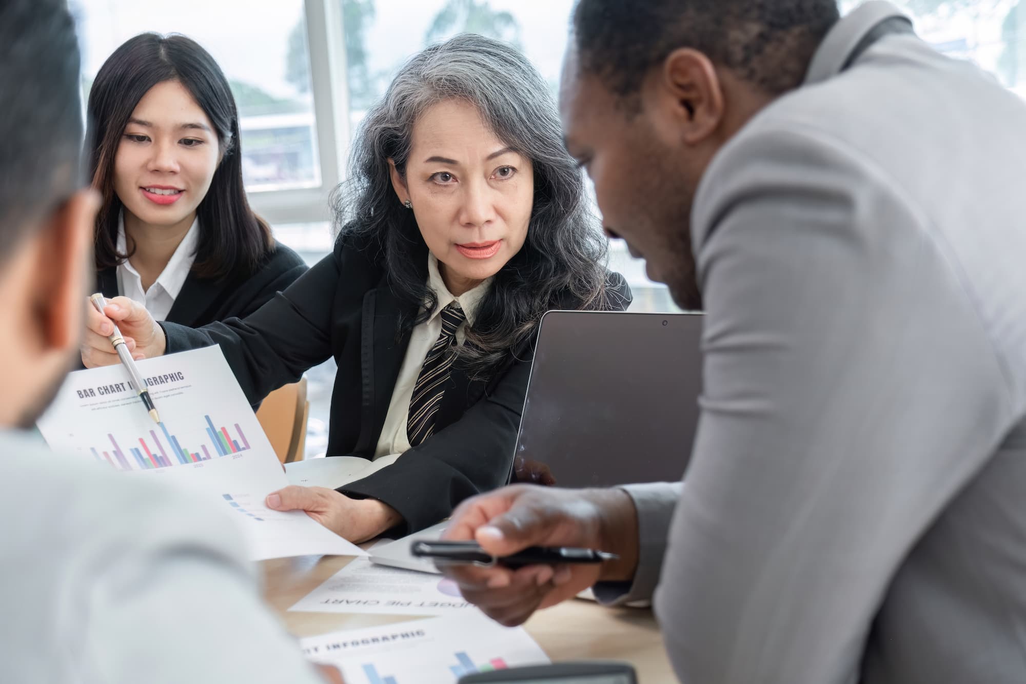 Advisors reviewing a bar chart with a client