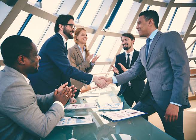 Business partners shaking hands in a meeting